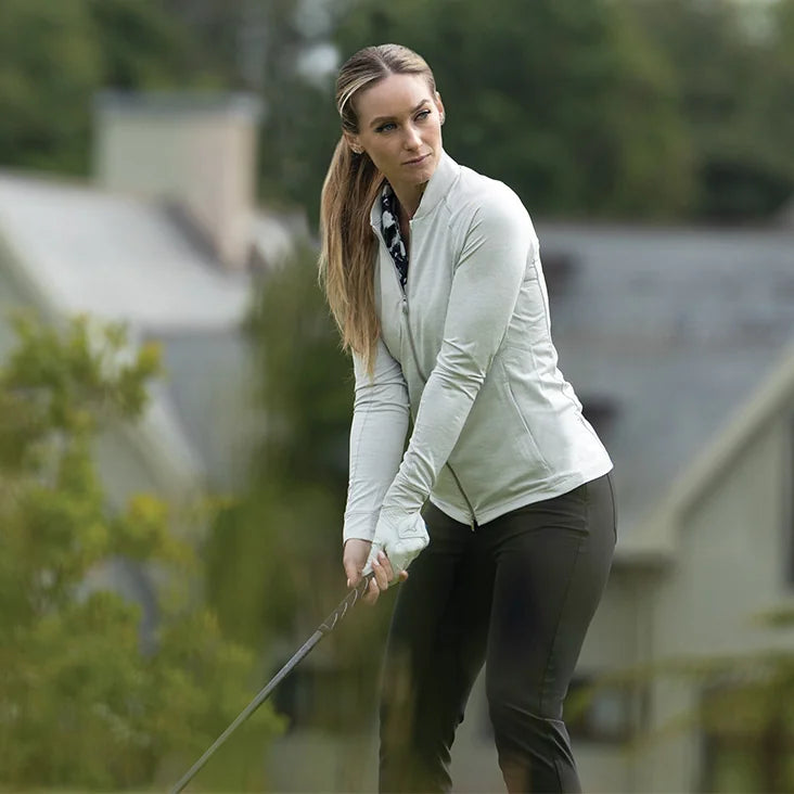 Woman playing golf with a blurred background