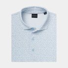 A folded light Cashmere Blue polo shirt with a dense micro-dot pattern, featuring a collar, three button placket.