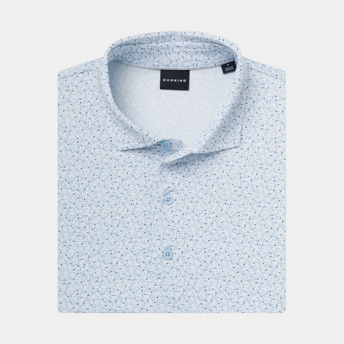 A folded light Cashmere Blue polo shirt with a dense micro-dot pattern, featuring a collar, three button placket.