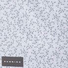 Close-up of a light Micro-Chip gray fabric with a scattered small dark gray leaf-like print and a dark gray DUNNING brand patch at the bottom left.