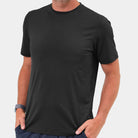 Person wearing a black t-shirt against a plain background